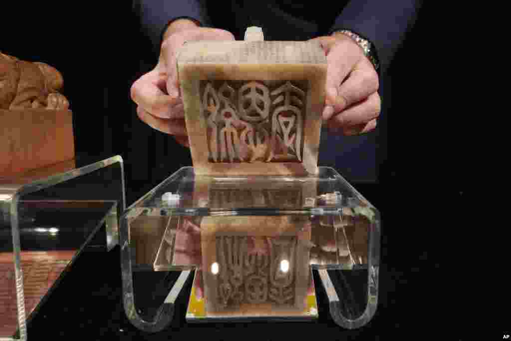 The Imperial Inscribed White Jade "Ji'entang" Seal for the Qianlong Period of China's Qing Dynasty is displayed during the Sotheby's auction preview in Hong Kong. The seal is expected to fetch $16.1 - 23.2 million.