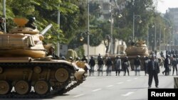 Army tanks and riot police are seen outside the presidential palace in Cairo, December 12, 2012. 
