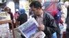 A man reads a newspaper headlining "Terrorist attack and kidnapping in In Amenas," at a news stand in Algiers, January 17, 2013. 