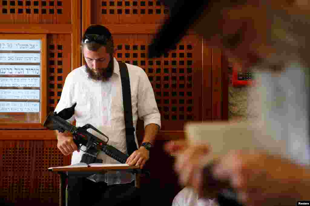 Ultra-Orthodox Jewish worshippers pray at the Western Wall in Jerusalem's Old City on Tisha B'Av. Tisha B'Av, a day of fasting and lament, commemorates the date in the Jewish calendar on which it is believed that First and Second Temples were destroyed in Jerusalem.