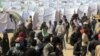 Migrant workers, who used to work in Libya and fled the recent unrest in the country, are seen in a refugee camp at the Tunisia-Libyan border, in Ras Ajdir, Tunisia, March 9, 2011. (AP Image)