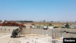 FILE - A member of the Libyan internationally recognized government forces is seen during a fight with Eastern forces, in southern Tripoli, Libya June 22, 2019.