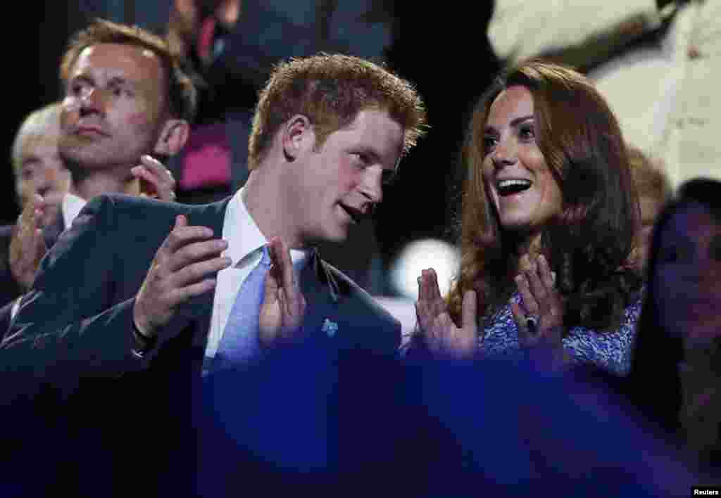 Britain's Prince Harry (L) and Dutchess of Cambridge Kate Middleton (R) applaud as they view the closing ceremony of the London 2012 Olympic Games at the Olympic Stadium August 12, 2012.