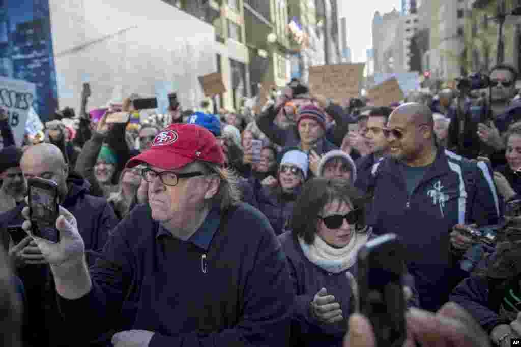 O realizador Michael Moore junta-se aos manifestantes durante os protestos contra o Presidente-eleito Donald Trump na 5ª Avenida, junto à Trump Tower em Nova Iorque, Nov. 12, 2016.