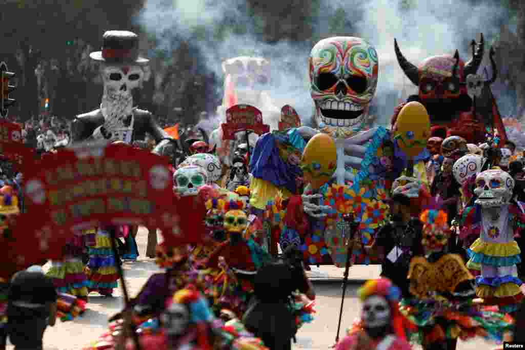 Skull figures are seen during a procession to commemorate Day of the Dead in Mexico City, Oct. 28, 2017.