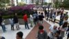 Voters stand in line to vote at a polling station during district council local elections, Hong Kong, Nov. 24, 2019. Voters are turning out in record numbers for an elect seen as a referendum on pro-democracy protests.