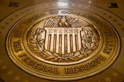 FILE - This Feb. 5, 2018, file photo shows the seal of the Board of Governors of the U.S. Federal Reserve System at the Marriner S. Eccles Federal Reserve Board Building in Washington.