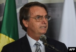FILE - Brazil's President Jair Bolsonaro delivers a speech in I in Itaipu,,Feb. 26, 2019.