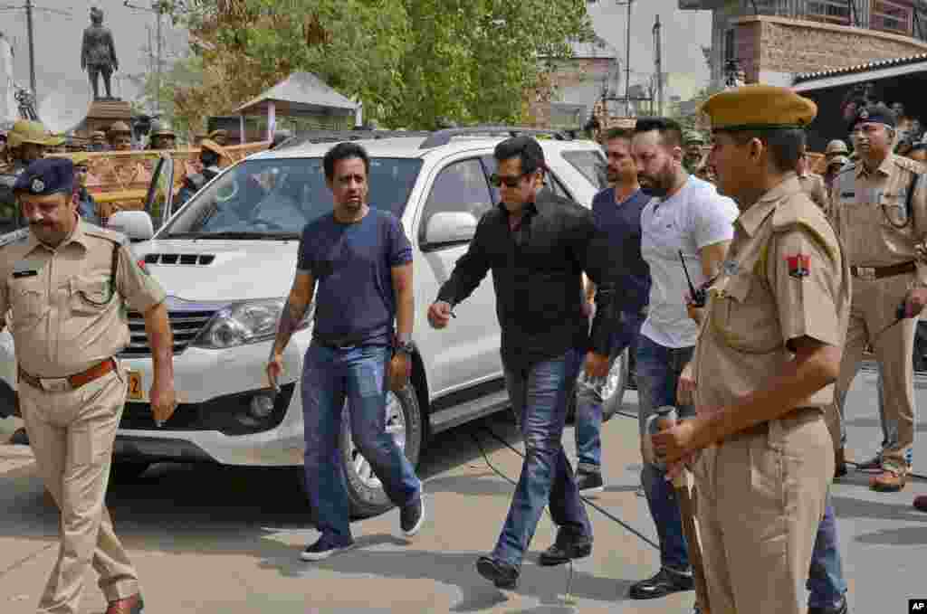 Bollywood star Salman Khan, center, arrives to appear before a court in Jodhpur, Rajasthan state, India. Khan was convicted of poaching rare deer in a wildlife preserve two decades ago and sentenced to five years in prison, with the trial judge describing him as a "habitual offender."