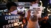 Protesters light candles while they hold banners, during a rally in metropolitan Manila, Philippines, Monday, Feb. 10, 2020. The Philippine government's chief lawyer asked the Supreme Court on Monday to shut down the country's largest TV network,…
