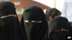 FILE - Saudi women attend the traditional Arda dance, or War dance, during the Janadriyah Festival of Heritage and Culture on the outskirts of the Riyadh, Saudi Arabia.