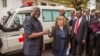 Sierra Leone's president Ernest Bai Koroma (L) is handed the keys to an ambulance by U.S. Embassy representative Kathleen FitzGibbon (C), one of five ambulances donated by the U.S., in Freetown, Sierra Leone, Sept. 10, 2014. 