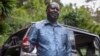 Kenya's opposition leader Raila Odinga speaks next to one of his vehicles he says was struck by a teargas canister fired by riot police, at his home in Nairobi, Kenya, March 31, 2023.