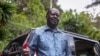 FILE - Kenya's opposition leader Raila Odinga speaks next to one of his vehicles he says was struck by a teargas canister fired by riot police, at his home in Nairobi, Kenya, March 31, 2023. 