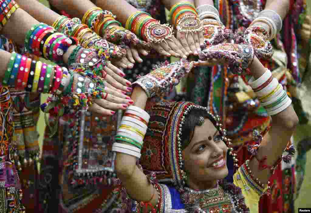 A girl dressed in traditional attire poses as she takes part in rehearsals for the "garba" dance ahead of Navratri festival in the western Indian city of Ahmedabad, Sept. 29, 2013.