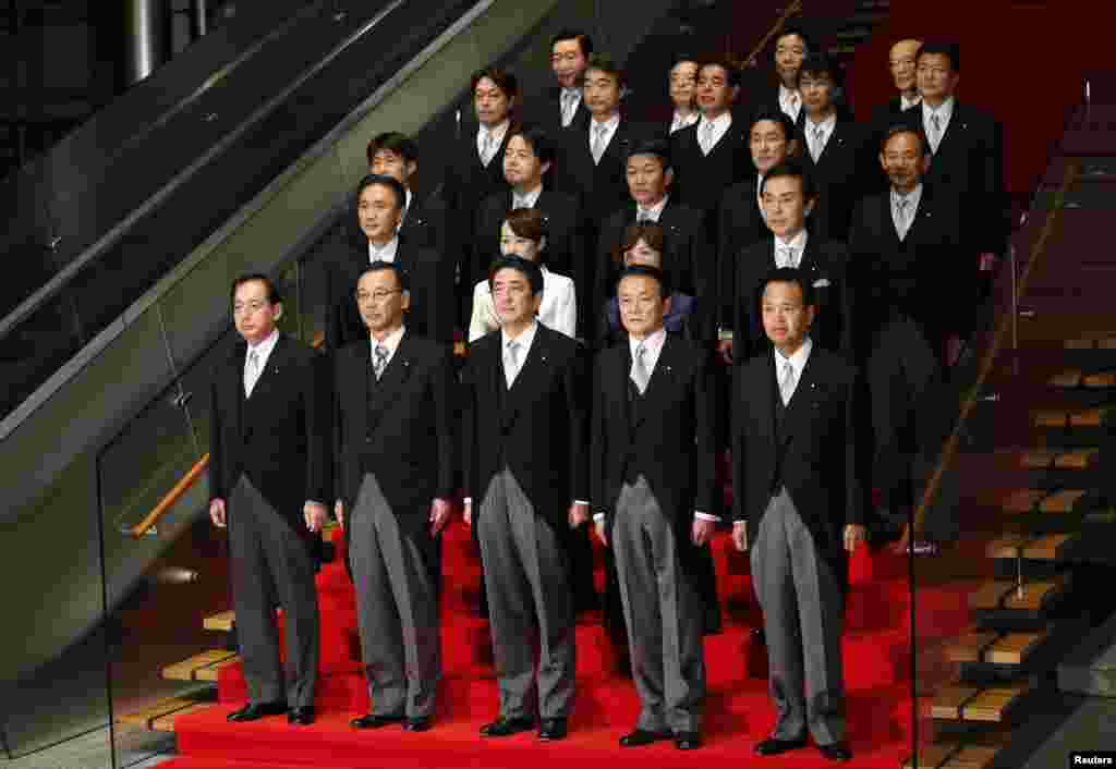 New Japanese Prime Minister Shinzo Abe (front C) and his cabinet ministers pose for a photo after their first cabinet meeting at Abe's official residence in Tokyo, December 26, 2012.