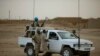 FILE - In this July 28, 2013 photo, United Nations peacekeepers stand guard at a polling station, during presidential elections in Kidal, Mali.