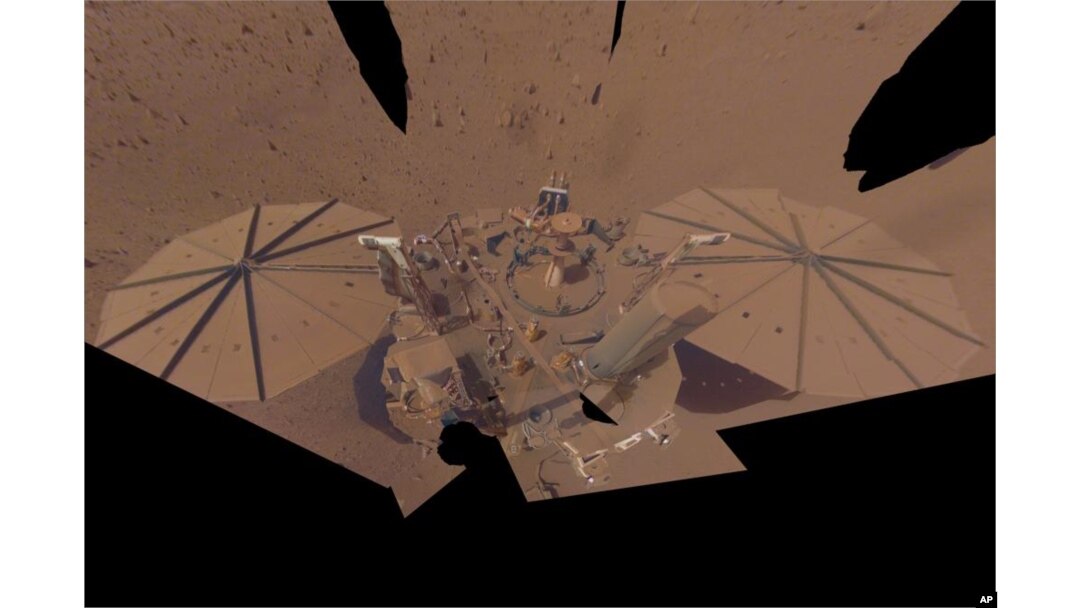 This image provided by NASA shows the InSight Mars lander in a selfie photo composite on April 24, 2022. The lander's solar panels have become covered with dust since the lander touched down on Mars in November 2018, which has led to a gradual decline in its power level. (NASA/JPL-Caltech via AP)
