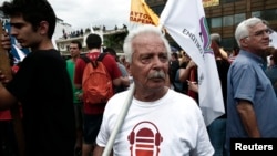 Protesters hold a rally outside the headquarters of Greek State broadcaster ERT, Athens, June 13, 2013. 