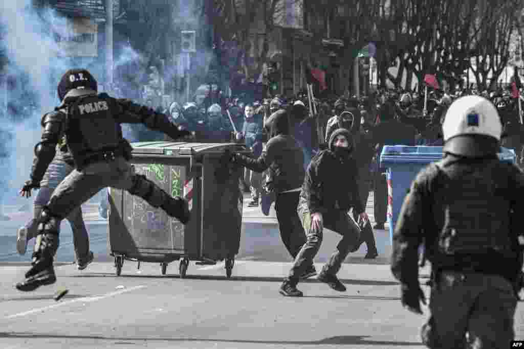 Protesters throw stones at riot police during clashes in Thessaloniki, Greece. Thousands of students take part in a demonstration against the operation of the evacuation of the Aristotle University by police.
