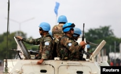 FILE - Peacekeepers serving in the United Nations Organization Stabilization Mission in the Democratic Republic of the Congo (MONUSCO) patrol in their armoured personnel carrier during demonstrations against Congolese President Joseph Kabila in the streets of Kinshasa, Dec. 20, 2016.