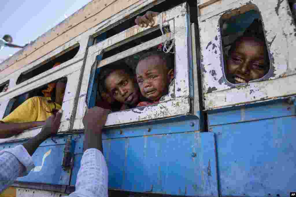 Tigray refugees who fled the conflict in the Ethiopia's Tigray, ride a bus going to the Village 8 temporary shelter, near the Sudan-Ethiopia border, in Hamdayet, eastern Sudan.