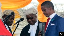 FILE - Edgar Lungu, right, is sworn in as president at an inauguration ceremony in Lusaka, Jan. 25, 2015.