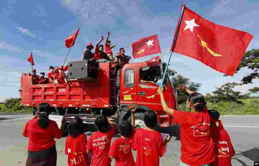 Supporters of Myanmar leader Aung San Suu Kyi's National League for Democracy (NLD) party waves the party flag and cheers from a truck during an election campaign in Naypyitaw for next month's general election.