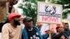 Nigerian activist and former presidential candidate Omoyele Sowore sits with activists during a protest over fuel and power price rises, near the U.S. embassy in Abuja, Nigeria, Oct. 1, 2020.