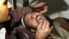 Doctor Abdul Salam, a dentist, checks a cavity of villager Gul Mohammad at his clinic in Kabul, Afghanistan, Saturday Dec.14, 2002. People living in villages often come to the city for medical check ups, as there are no doctors in the villages. (AP Photo/