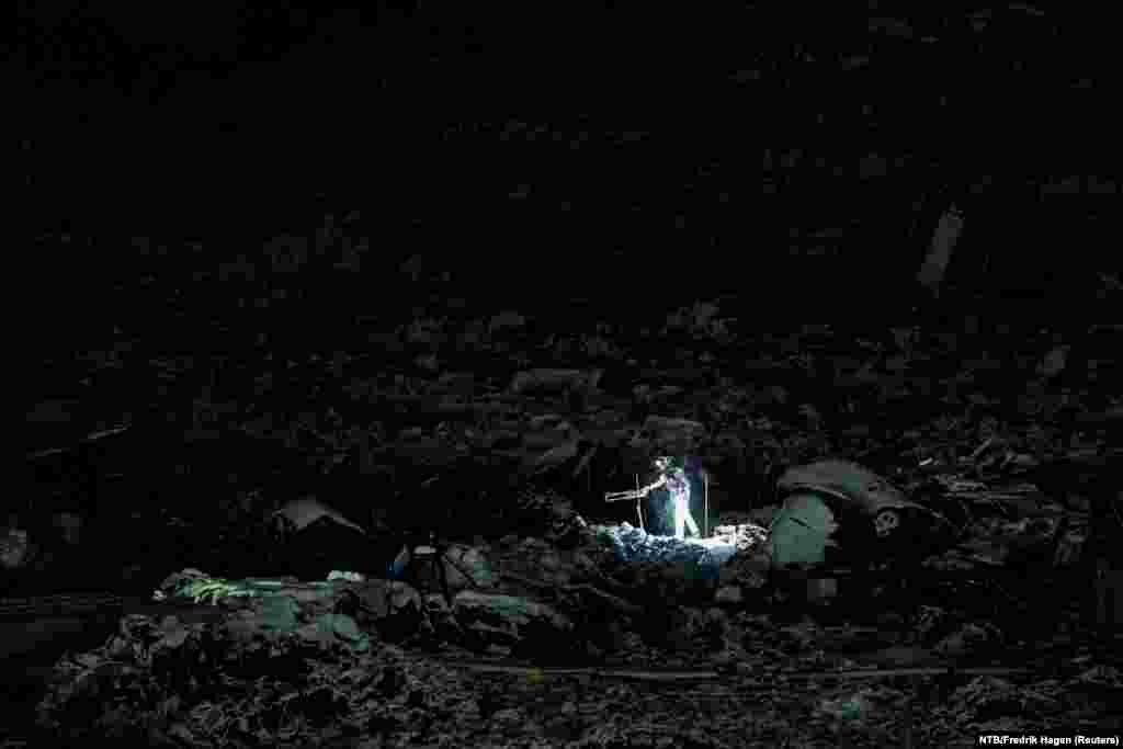 Rescue workers continue their efforts on the site of a major landslide that occurred in Ask, Gjerdrum, Norway, Jan. 4, 2021.