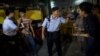 在香港旺角商業區的一場本土派示威中，警察檢查“本土民主前線”的發言人黃台仰（左起第二人）的身份證（2015年6月21日）