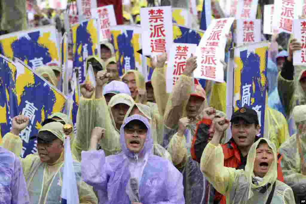 Labor rights activists shout while holding signs reading "Forbid Temporary Worker Services" during a rally for labor rights on international Labor Day in Taipei, Taiwan.