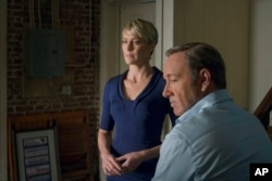File - This image released by Netflix shows Robin Wright as Clair Underwood, left, and Kevin Spacey as Francis Underwood in a scene from "House of Cards." The second season of the popular original series premieres, Feb. 14, 2014 on Netflix.