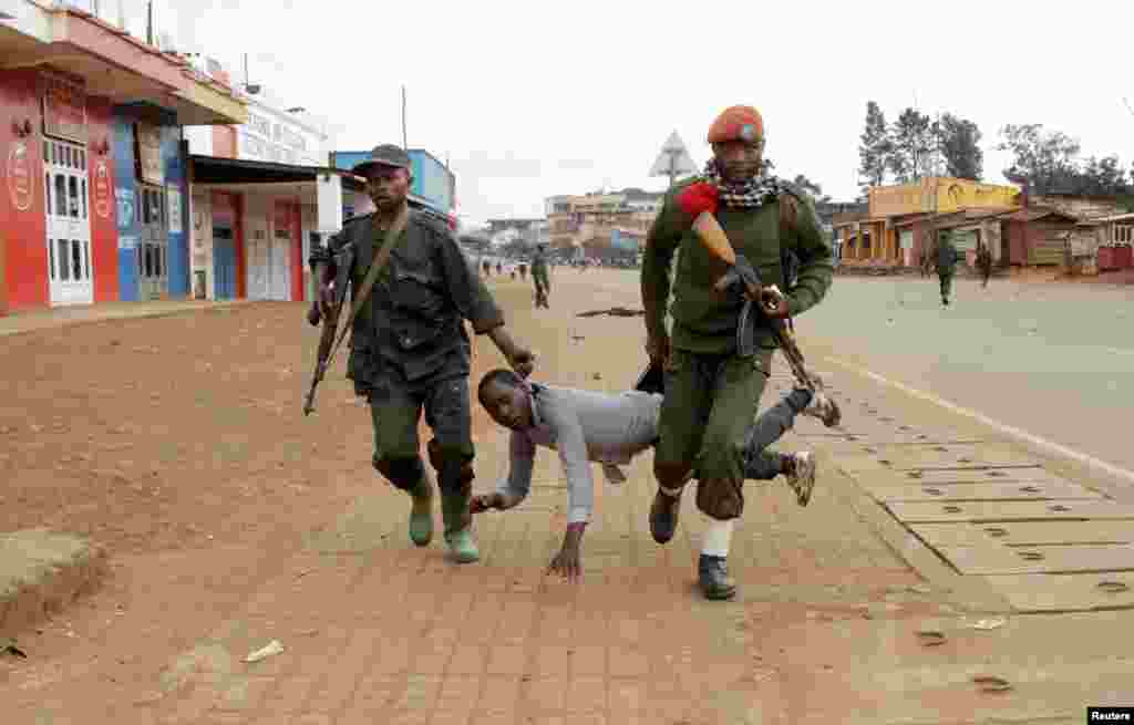 Congolese soldiers arrest a civilian protesting against the government's failure to stop the killings and inter-ethnic tensions in the town of Butembo, in North Kivu province, Democratic Republic of Congo.