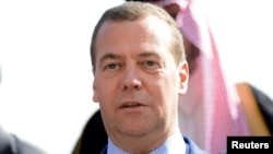 Russian Prime Minister Dmitry Medvedev is seen in a group photo during the second day of the international conference on Libya in Palermo, Italy, Nov. 13, 2018.