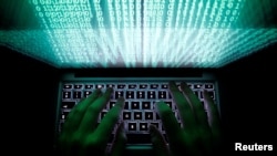 FILE - A person types on a computer keyboard in this illustration photo taken Feb. 28, 2013. 