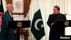 Pakistan's Prime Minister Nawaz Sharif (R) speaks during a joint news conference as Afghan President Hamid Karzai listens at the prime minister's residence in Islamabad, Aug. 26, 2013.