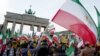 People demonstrate in support of protests across Iran, Jan. 6, 2018, in front of the Brandenburg Gate in Berlin.
