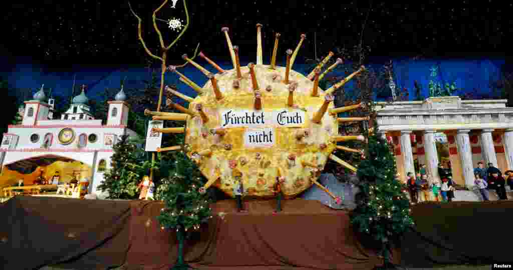 A papier mache model of the coronavirus shows the inscription reading "Do not be afraid" inside the Roman Catholic Church of St. Martinus in Renningen near Stuttgart, Germany.