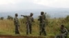 Soldiers from the Democratic Republic of Congo (DRC) rest near the town of Kibumba at its border with Rwanda after fighting broke out in the Eastern Congo town, June 11, 2014.