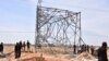Nigerian security forces are seen on the site of a sabotage attack allegedly perpetrated by Boko Haram against electical infrastructures on the outskirts of Maiduguri on Feb. 12, 2021.