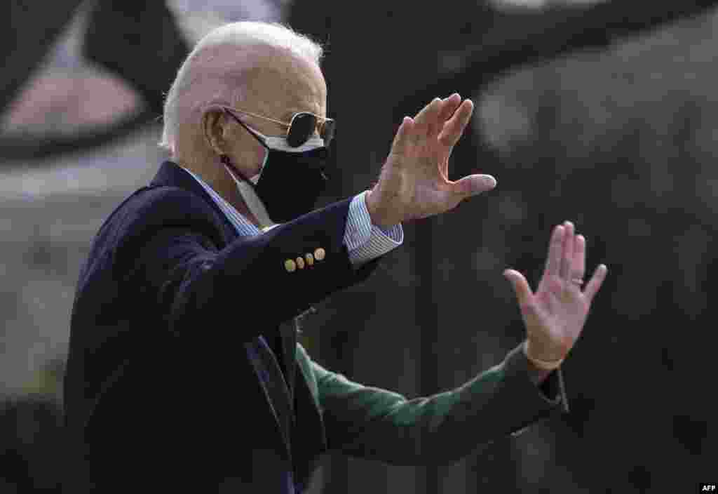 U.S. President Joe Biden and first lady Jill Biden wave as they walk to Marine One on the South Lawn of the White House, to travel to Texas after a winter storm left millions without electricity and clean water for days.