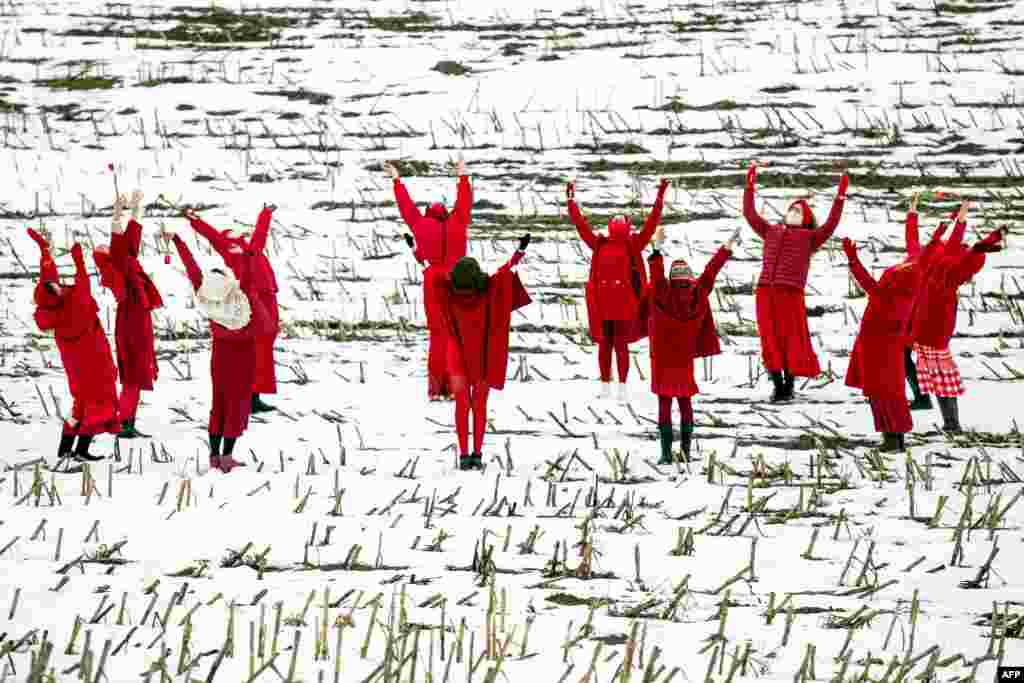 Women in red clothing dance as they welcome the meteorological spring during a protest against the Belarus presidential election results near the village of Maloje Zapruddzie, some 95 kilometers northwest of Minsk.
