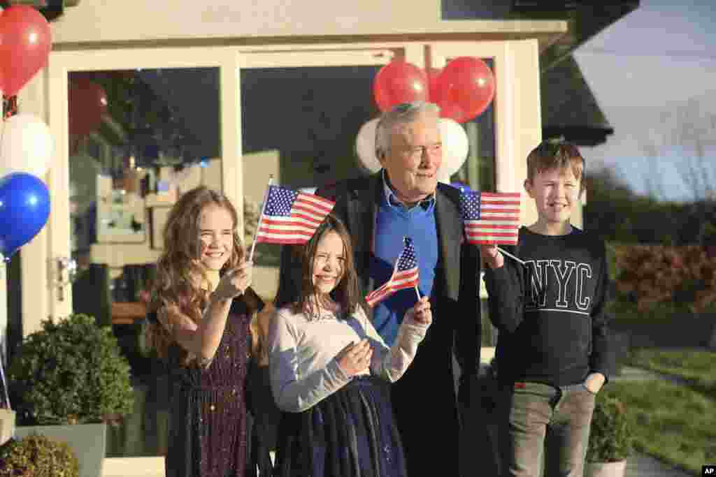 Joe Biden's cousin Brendan Blewitt with his grandchildren Emily, Lauren, and Darragh wave their U.S. flags to the media from their home in Knockmore, near the town of Ballina in Ireland.