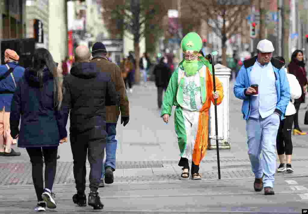A man dressed as St Patrick walks down O'Connell street in Dublin, Ireland. The St Patrick's Day parades across Ireland were canceled for the second year due to COVID-19 pandemic.