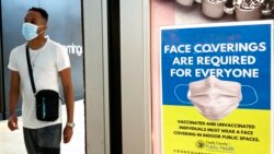 FILE - An information sign is displayed at a department store in Rosemont, Ill., Aug. 26, 2021.