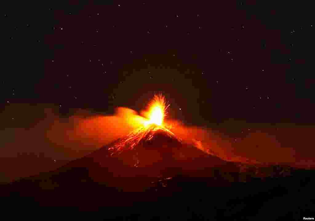Large streams of red hot lava shoot into the night sky as Mount Etna, Europe's most active volcano, leaps into action, seen from the village of Fornazzo, Italy, Feb. 3, 2021.