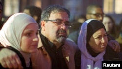 Namee Barakat with his wife, Layla (R) and daughter Suzanne, family of shooting victim Deah Shaddy Barakat, attend a vigil on the campus of the University of North Carolina in Chapel Hill, N.C., Feb. 11, 2015.