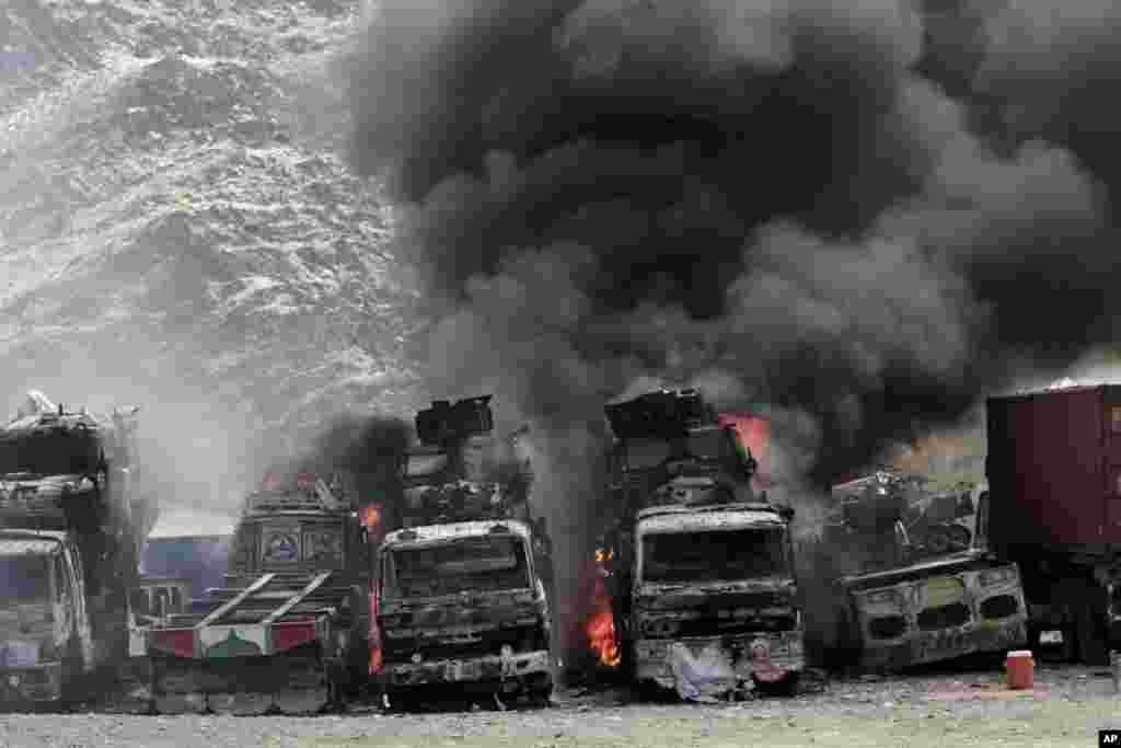 Smoke rises from NATO supply trucks following an attack by militants in Torkham, Afghanistan, Sept. 2, 2013.